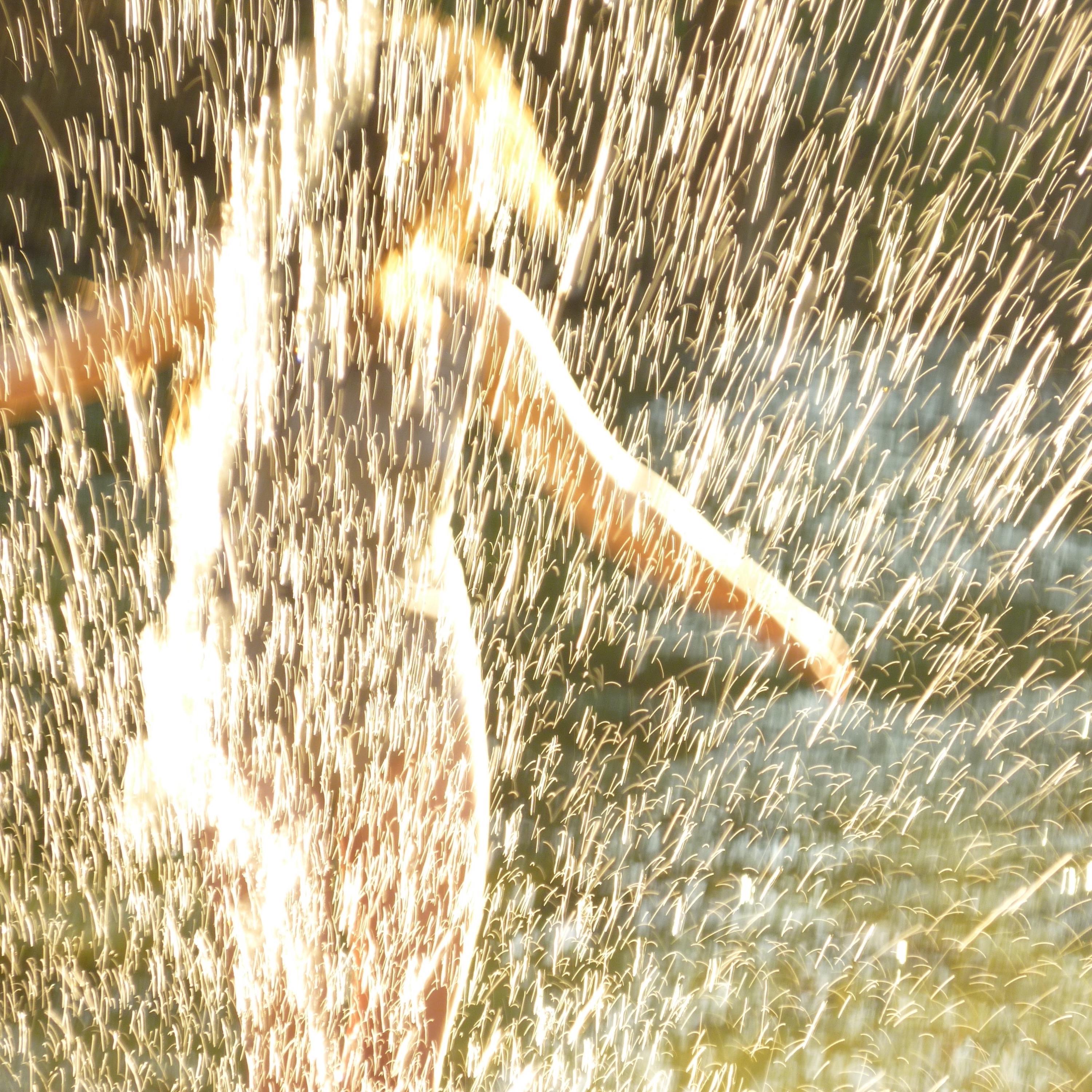 throwing sparks in the afternoon sun